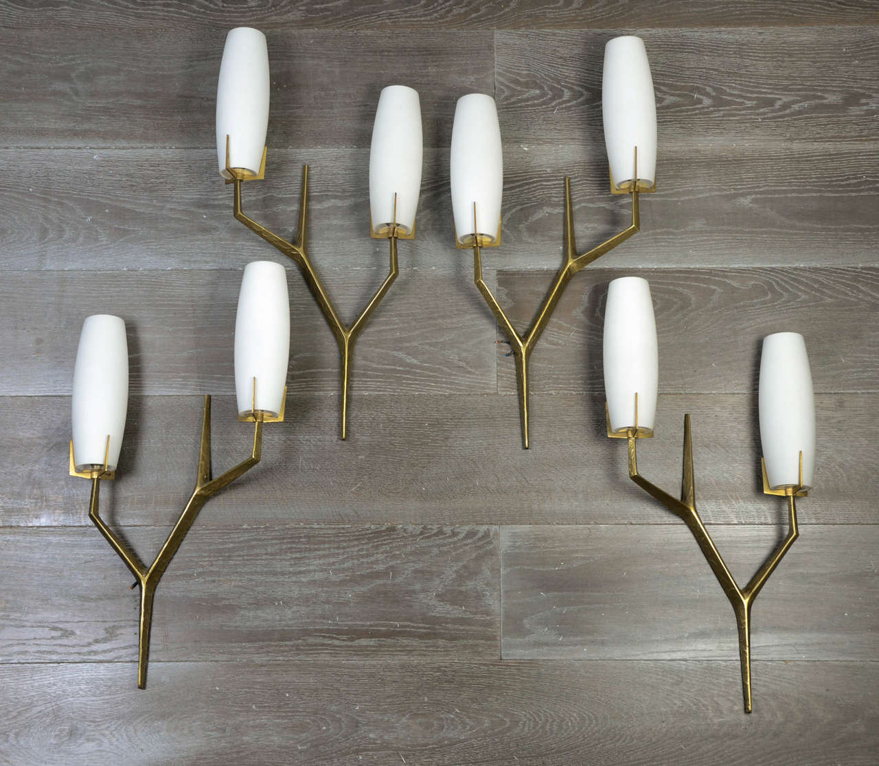 Very elegant set of four wall lamps (two pairs), in bronze, stylized motive with original white opaline glass.
By Arlus.
With eight opaline glass.