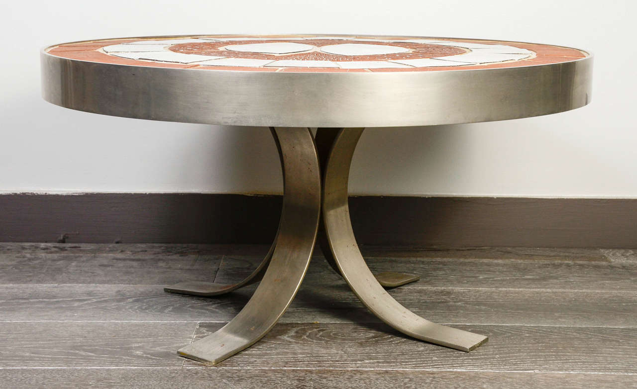 Stocky coffee table in steel and ceramic , various colors representing a bird.
Typical of Jacques Pouchain 's work.