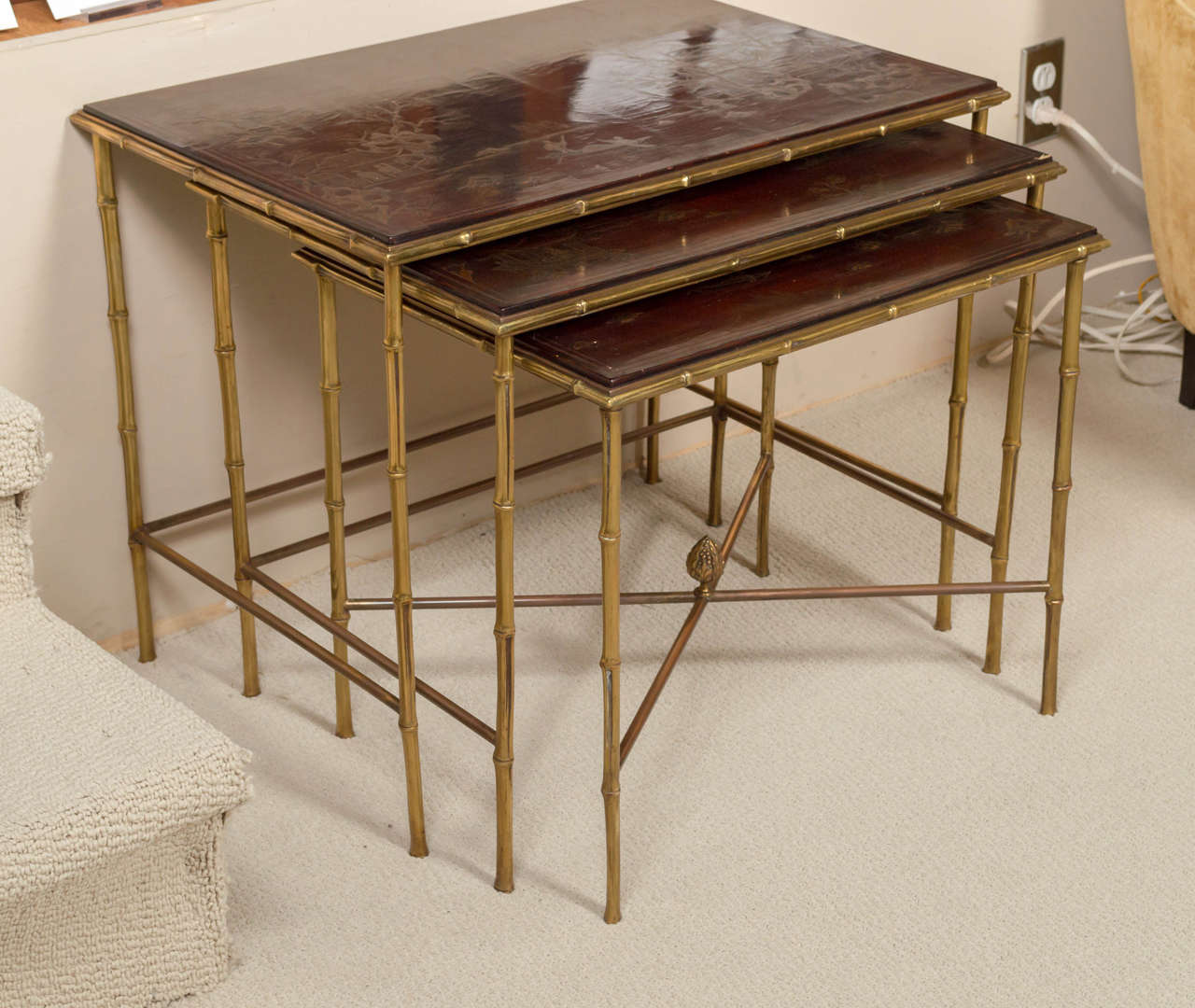 Maison Bagues elegant set of bamboo-motif patinated brass and chinoiserie lacquered top Nesting Tables. France, circa 1960
The smallest table measures 20-3/4