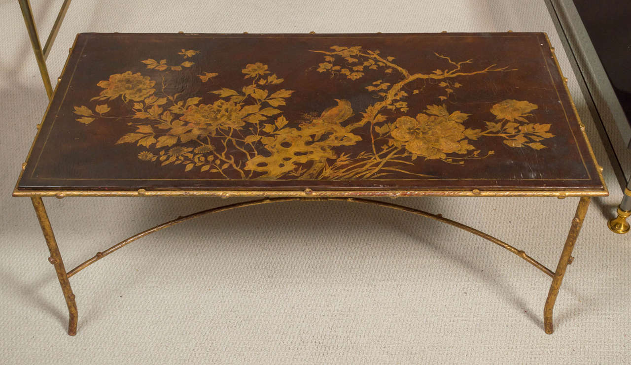 A unique Maison Bagues, cocktail table with branch motif base in gilt-metal, and lacquered Chinoiserie top. France, circa 1960.