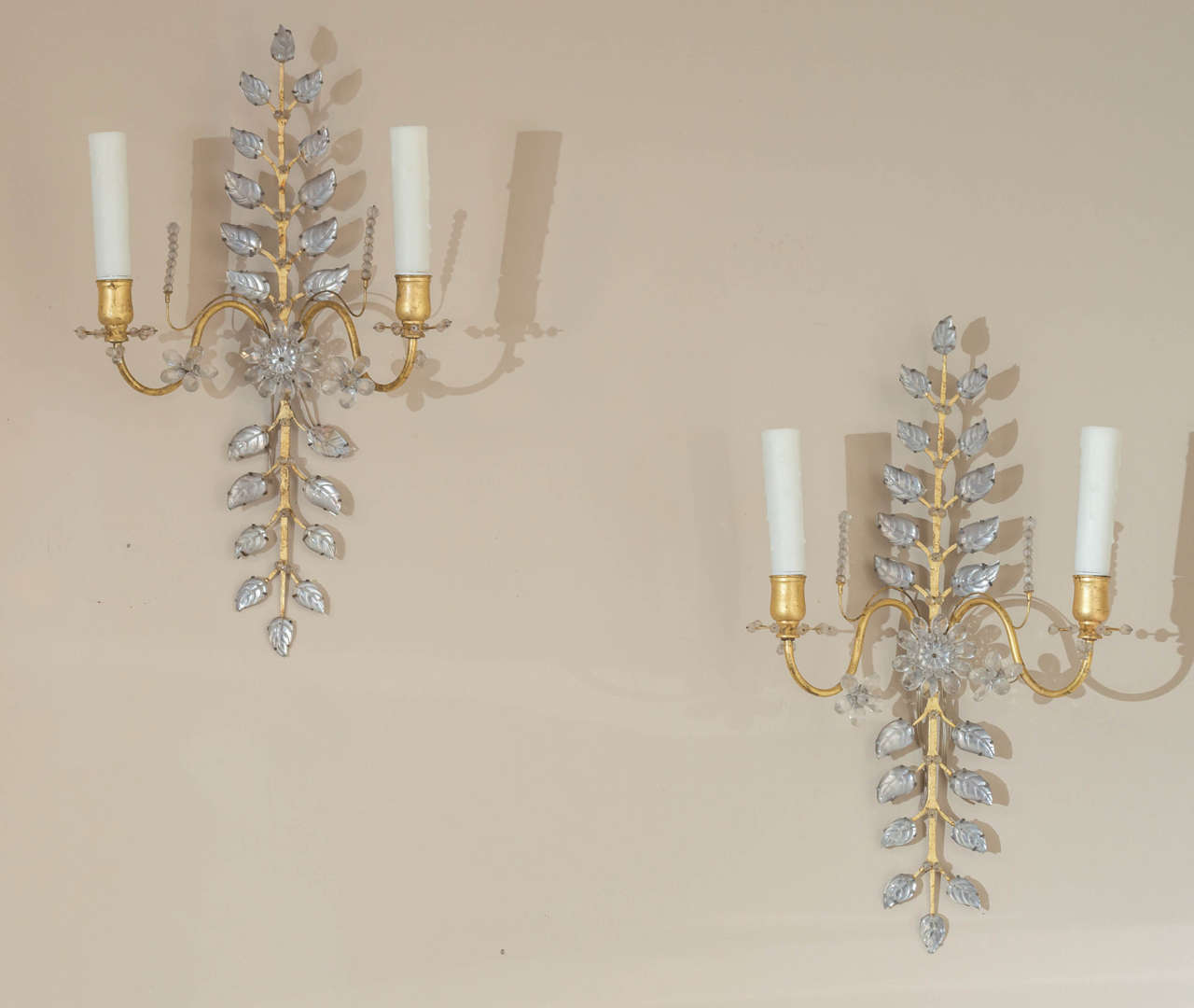 Maison Bagues -  A pair of gilt metal and glass, two-light sconces.

France, circa 1970.