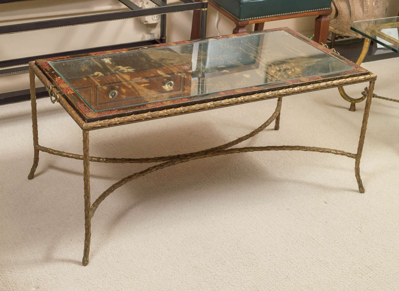 Maison Bagues - Palm leaf motif bronze cocktail table with an antique Chinese lacquered panel depicting a landscape. glass top. France circa 1960s.