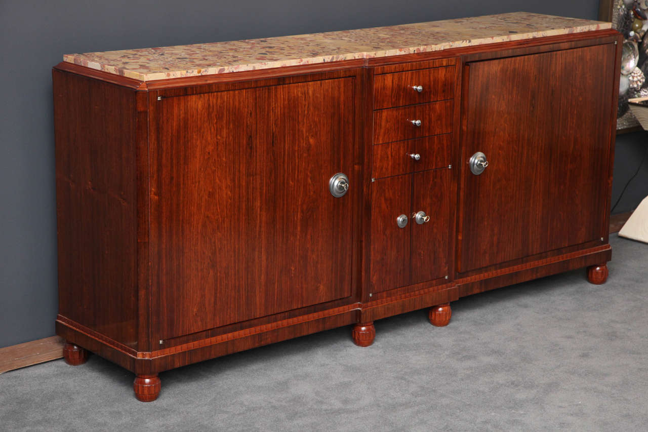 Early Art Deco sideboard in mahogany with original chromed-metal hardware and Brêche d’Alep marble top, by Jules Leleu. Model number 657

For an illustration of a similar cabinet, see Siriex, Françoise. The House of Leleu. New York: Hudson Hills