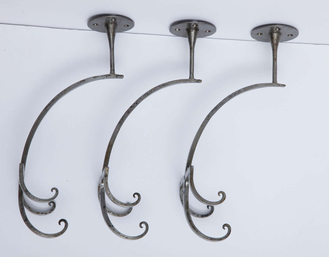 Set of three wrought iron hooks by Jules Bouy.