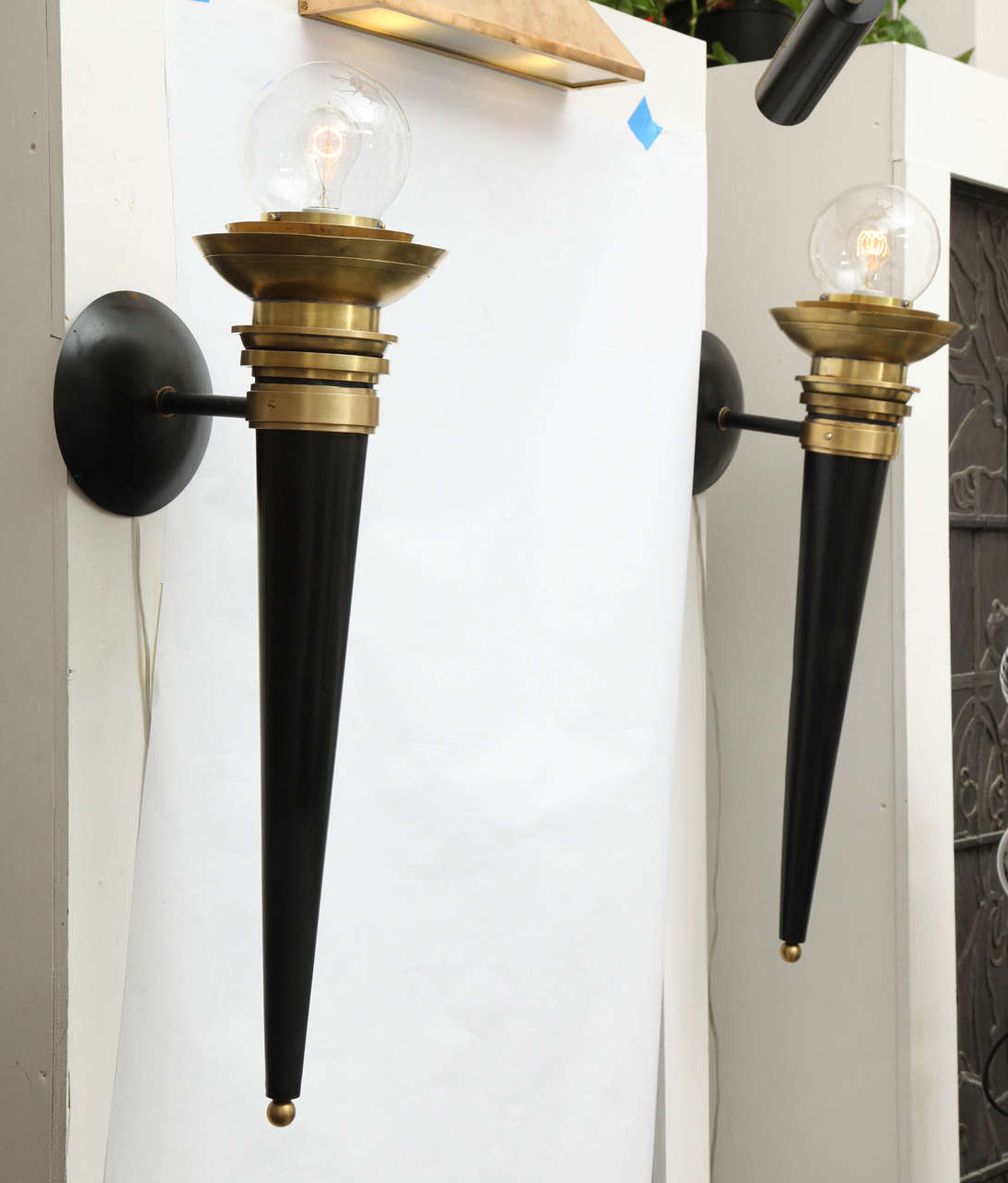 A pair of 1940s Art Moderne sconces, crafted of polished brass, painted metal and glass.

10491