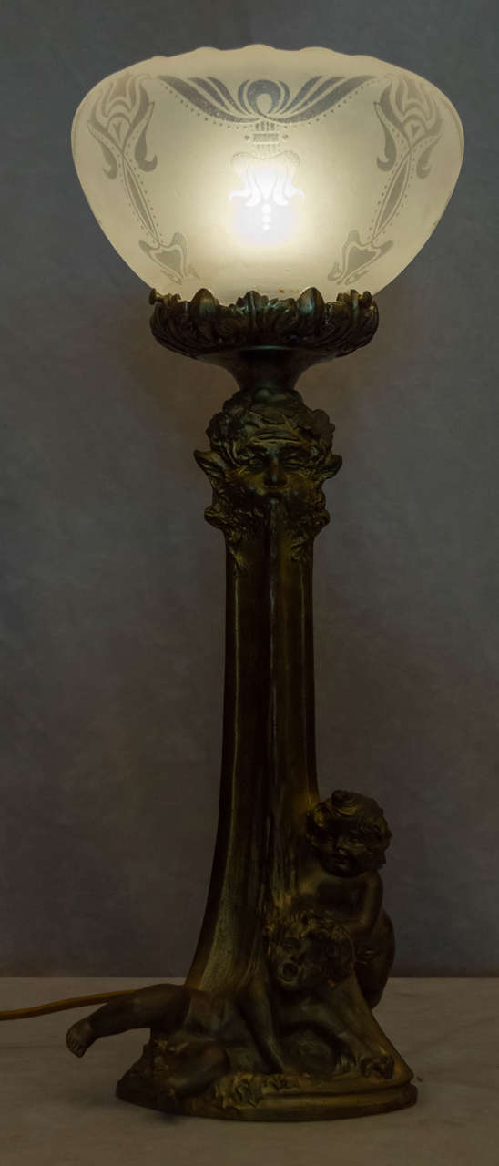 How can you not smile when taking a gander at this wonderful little lamp? The two children are under a fountain with water pouring out of this mythological head. Fine quality as to be expected when you see the "Louchet" foundry seal. The