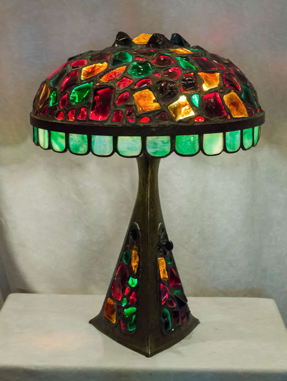 This incredibly colorful lamp is one of the more exotic examples of this style table lamp. The jewels are all hand-cut and light up with very vibrant colors. It was very difficult to accurately capture the richness of the colors,particularly the