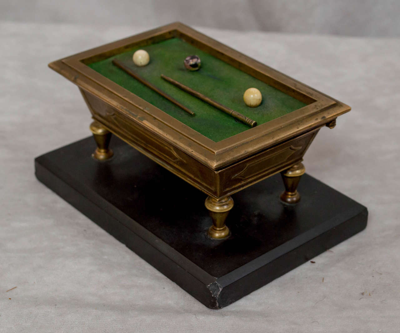 We love getting the unusual items,particularly when they are in bronze. The unique box is a great representation of an old billiard table. This is before pocket billiards was invented. Just 3 balls,and no pockets. Each player was assigned a ball.