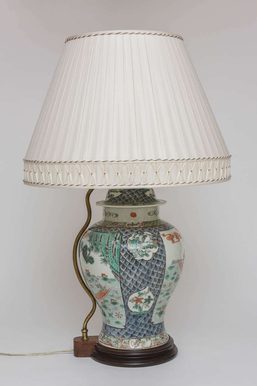 Decorated with figures boating in a river setting. With custom pleated shade by Abat-Jour. Height of vase is 17