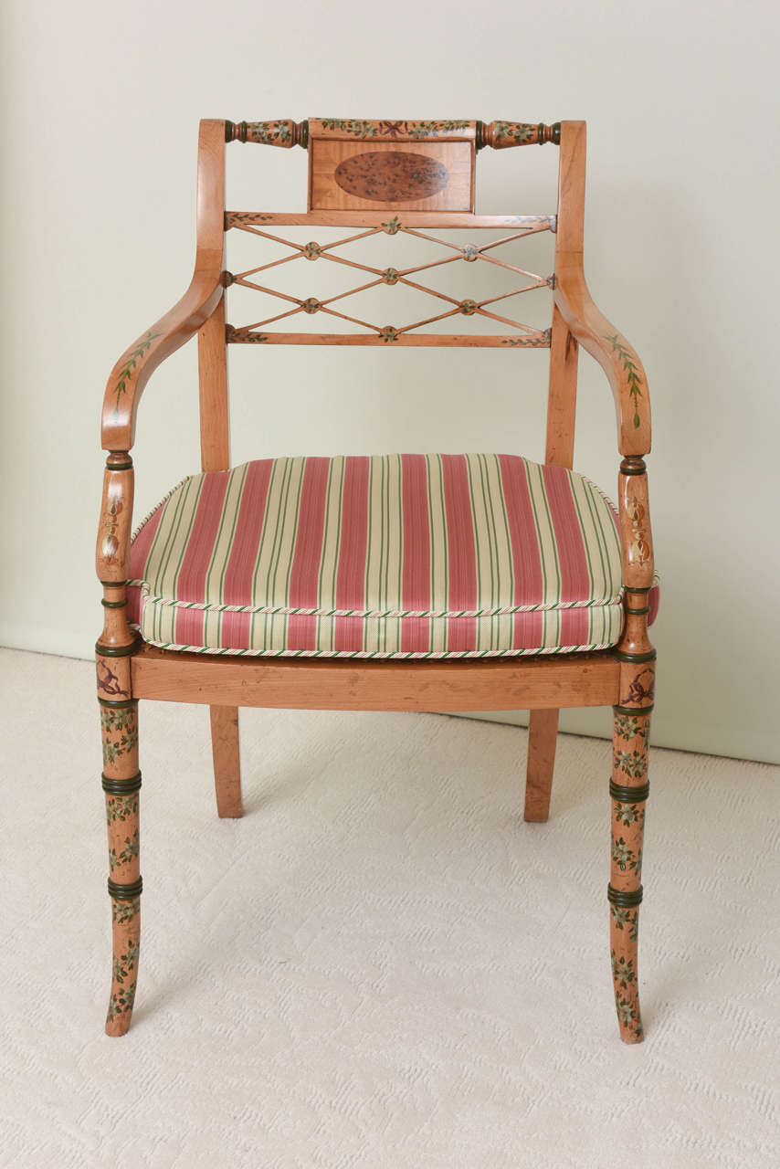 Each with rectangular back centered by a burr elm oval panel over a pierced trelliswork back splat; the loose squab cushion over a caned seat raised on fax bamboo tapering legs; decorated throughout with polychrome charming floral trailing vine work.