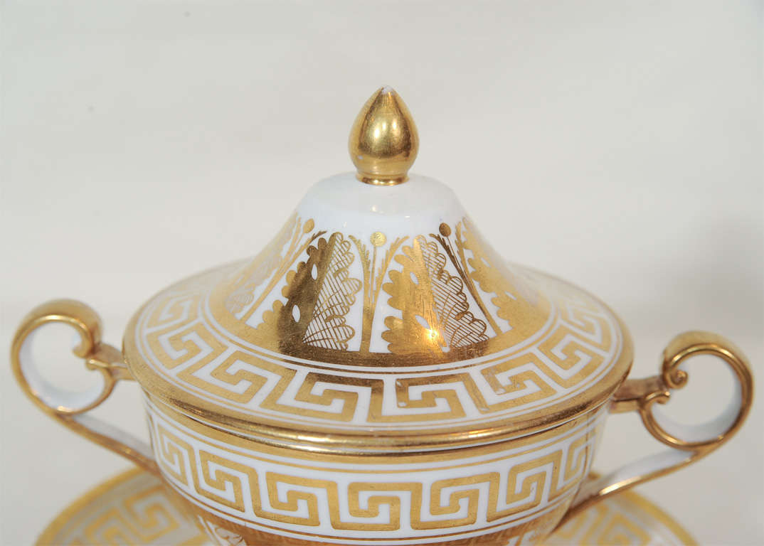 Coalport created this covered cup at the beginning of the 19th century. The white and gold Greek key and acanthus leaf design uses 2 of the most popular symbols from the neoclassical Greek and Roman revival period. Beginning in the third quarter of