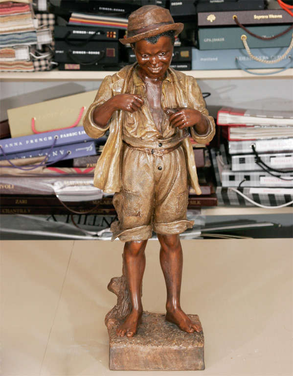 A lovely Goldscheider terracotta <br />
figure of a young fisher <br />
man in a bronze and <br />
polychrome palette.<br />
Stamped to base.