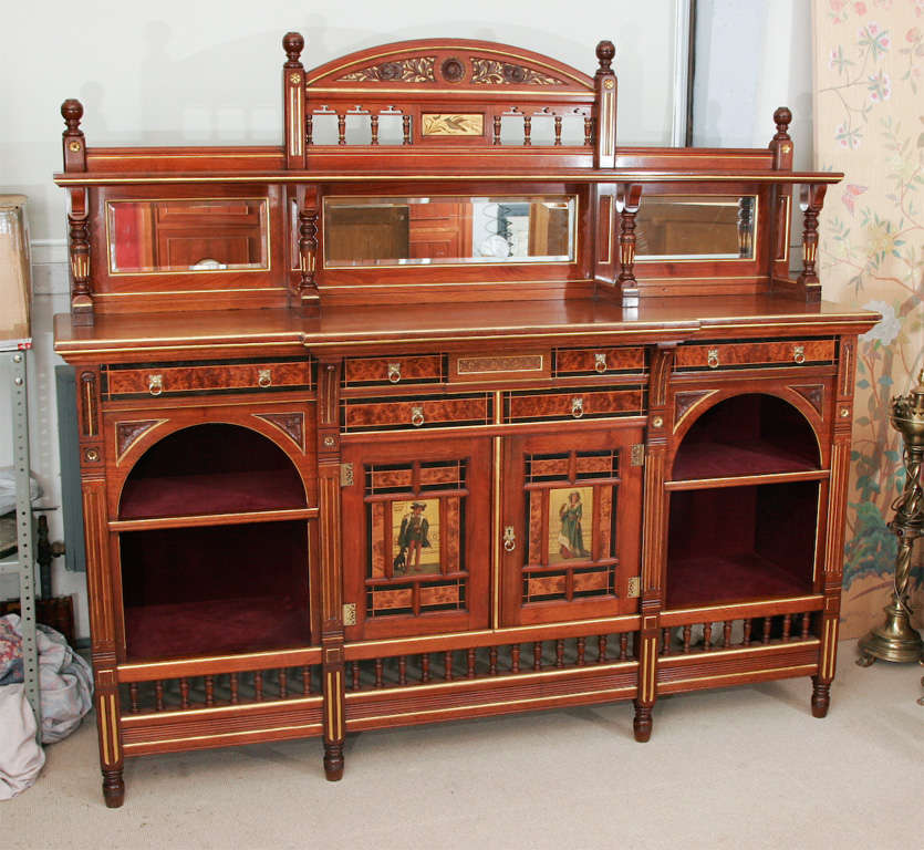 A superb walnut and Thuya display sideboard by Gillows of Lancaster to the designs of Bruce Talbot. With inlaid details, carving and highlights and doors with neoclassical ladies. With spindle gallery to the base.

Stamped: Gillows of
