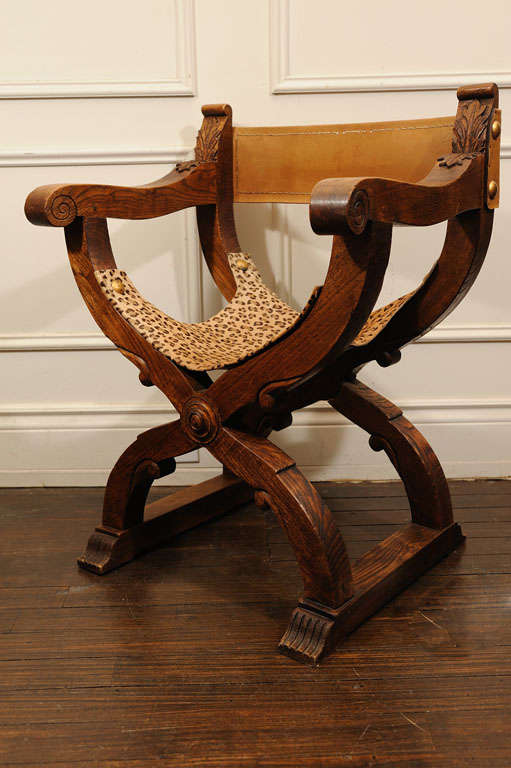 Wooden frame, partially folding Chair. The back is in original Leather. The original seat is replaced with leopard print Cow Hide.Original Lg. nails are been reused.