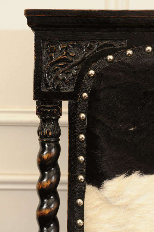 Cowhide Pair of Black, Carved Chairs upholstered in Cow Hide For Sale