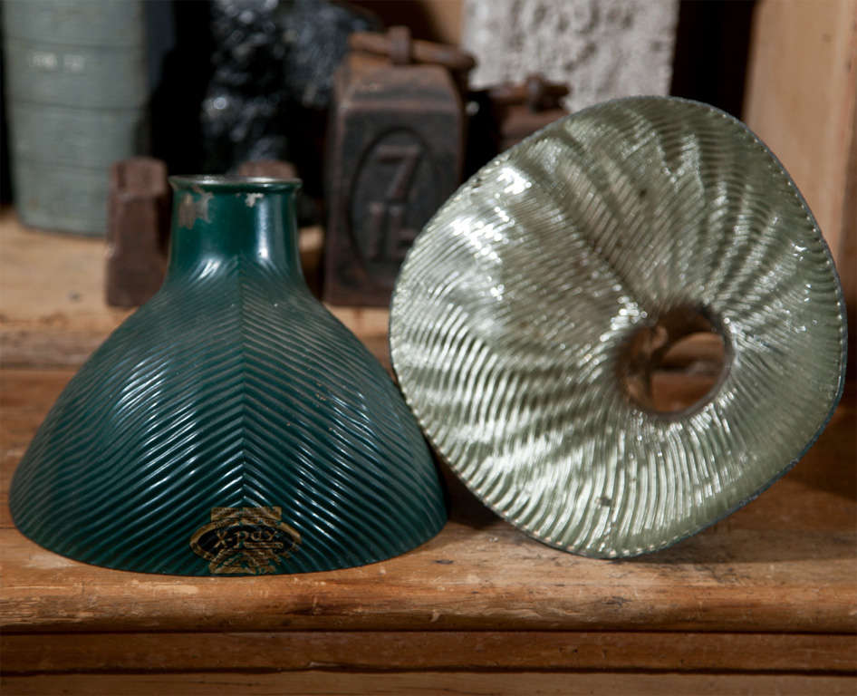 This is a wonderful pair of ribbed clamshell-shaped mercury glass shades, painted dark green on the outside and with a reflective surface inside. Perfect on an industrial polished steel extension or desk lamp. Signed 