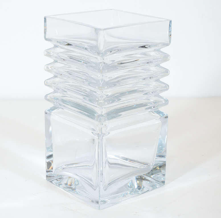 This stunning vase features a rectalinear stepped design in translucent crystal. It embodies the clean lines of Scandinavian mid-century modernist design at its best. 

Finnish, Circa 1950

Dimensions:
4"D X 4"W X 7.75"H