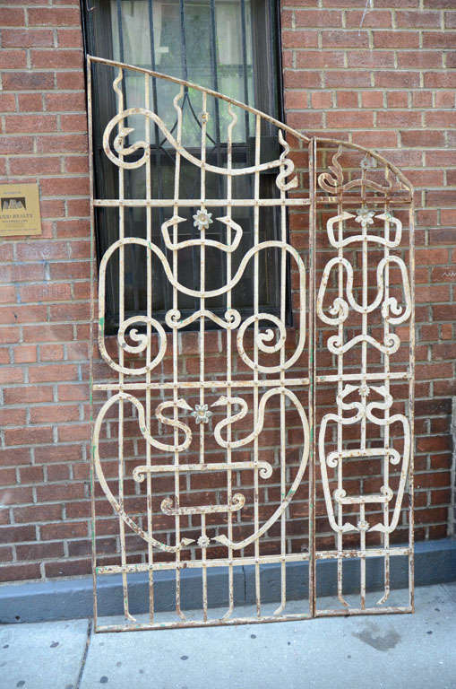 Sectional Iron gate with Egyptian serpentine design, antique white patina, in four pieces. Could be used outdoor or indoors as screen.