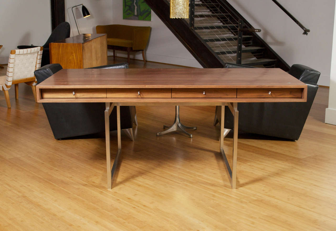Bodil Kjaer desk in Walnut featuring a sleek, four drawer design, one of which is lockable by key. This is a Licensed Reproduction of the 1960’s Classic.
