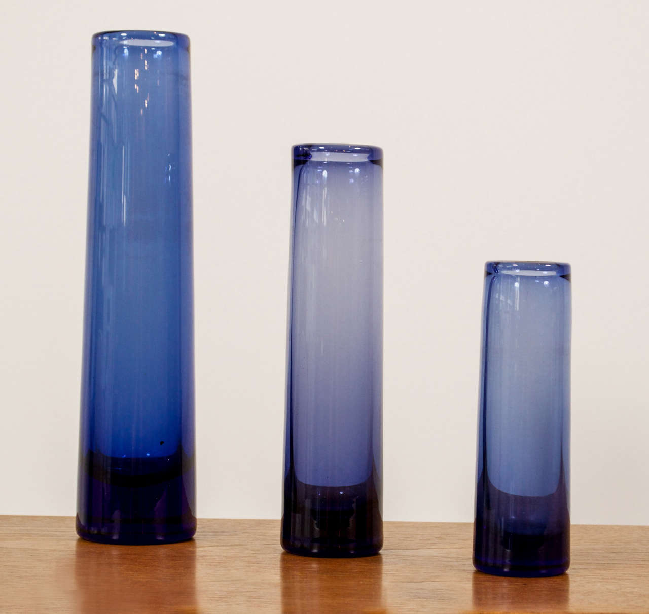 A group of three glass vases in various heights and shades of blue by Per Lutken for Holmegaard.
We have many varieties of shapes and sizes in the glass work of Per Lutken.  Please call for more information.