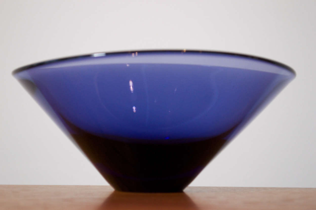 A deep, asymmetrical bowl of blue glass by Per Lutken for Holmegaard, Denmark c. 1960.