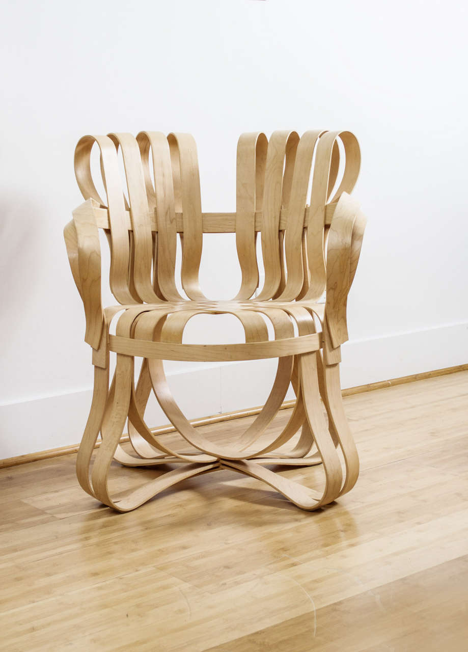 This beautiful bent Maple chair from the Gehry Collection for Knoll is heat - stamped with  Frank Gehry's signature, the Knoll logo,  and the date of production. It is rigid, yet pliant. It offers ergonomic movement and the Maple laths spring back
