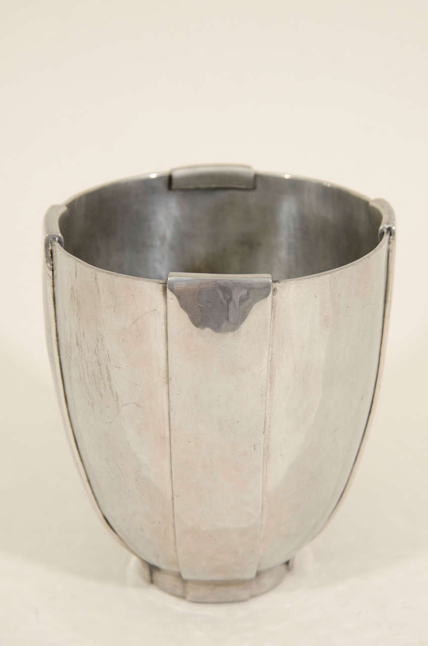Hammered metal vase with four applied vertical straps.
Signed:  