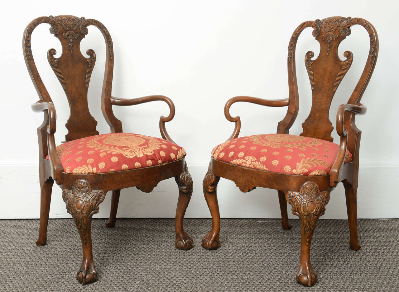 These are superb pair in solid mahogany open armchairs made by Bakers, USA.
They are in the Queen Anne style on Queen Anne legs with very nice carvings to the top. The back also is Queen Anne style with carved top rail with scroll arms. The seats