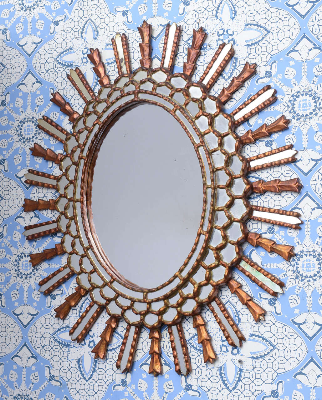 Very original oval starburst with plenty of mirrors and wood details.