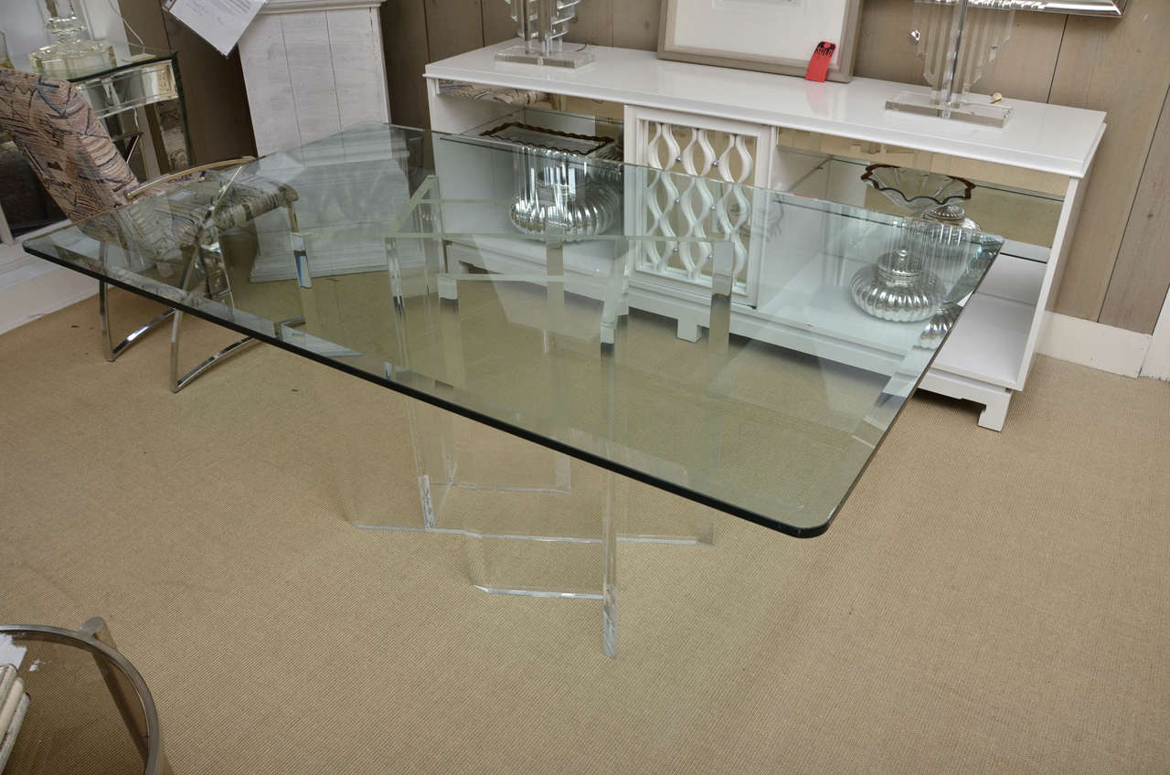 Dining table with attractive Lucite base and beveled glass top.