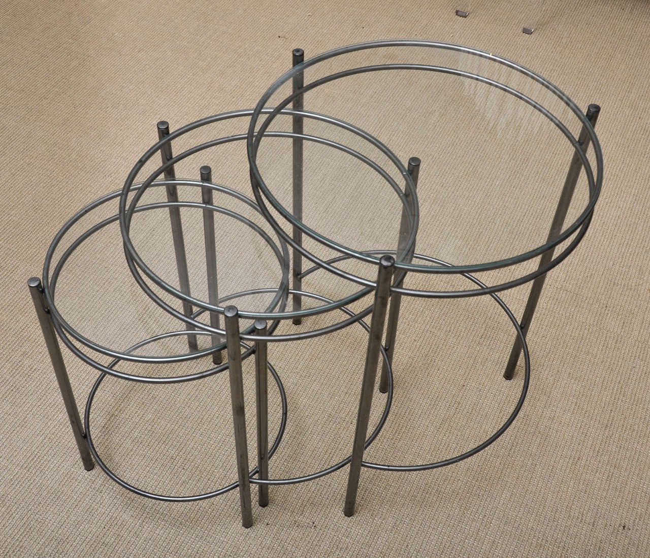 An attractive set of three round metal and glass nesting tables.