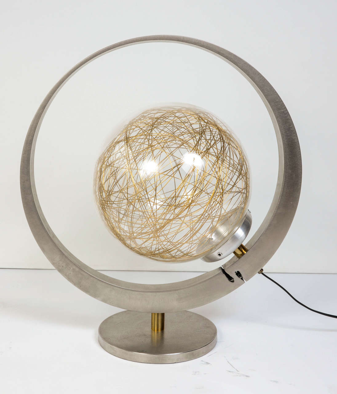 Imposing lamp designed and manufactured by French artist Hisle, the saturn is made of solid stainless steel discs from Industrial origin, brass spacer and a handblown glass with insertion of brass wire.