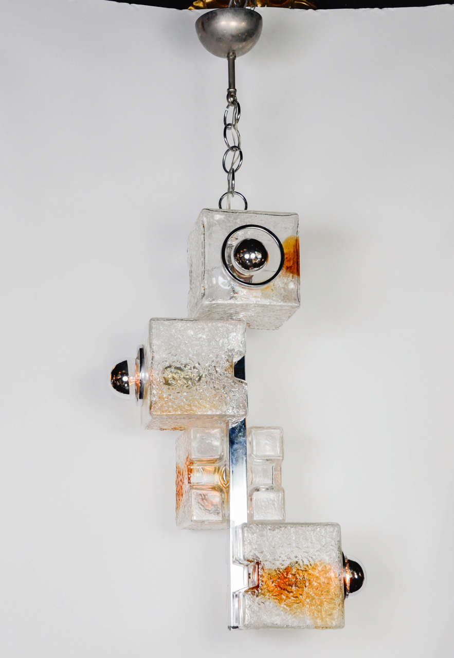 Pair of chandeliers,Poliarte,Italy, circa 1970. Chrome and thick cut glass, each cube has a colored amber face.
