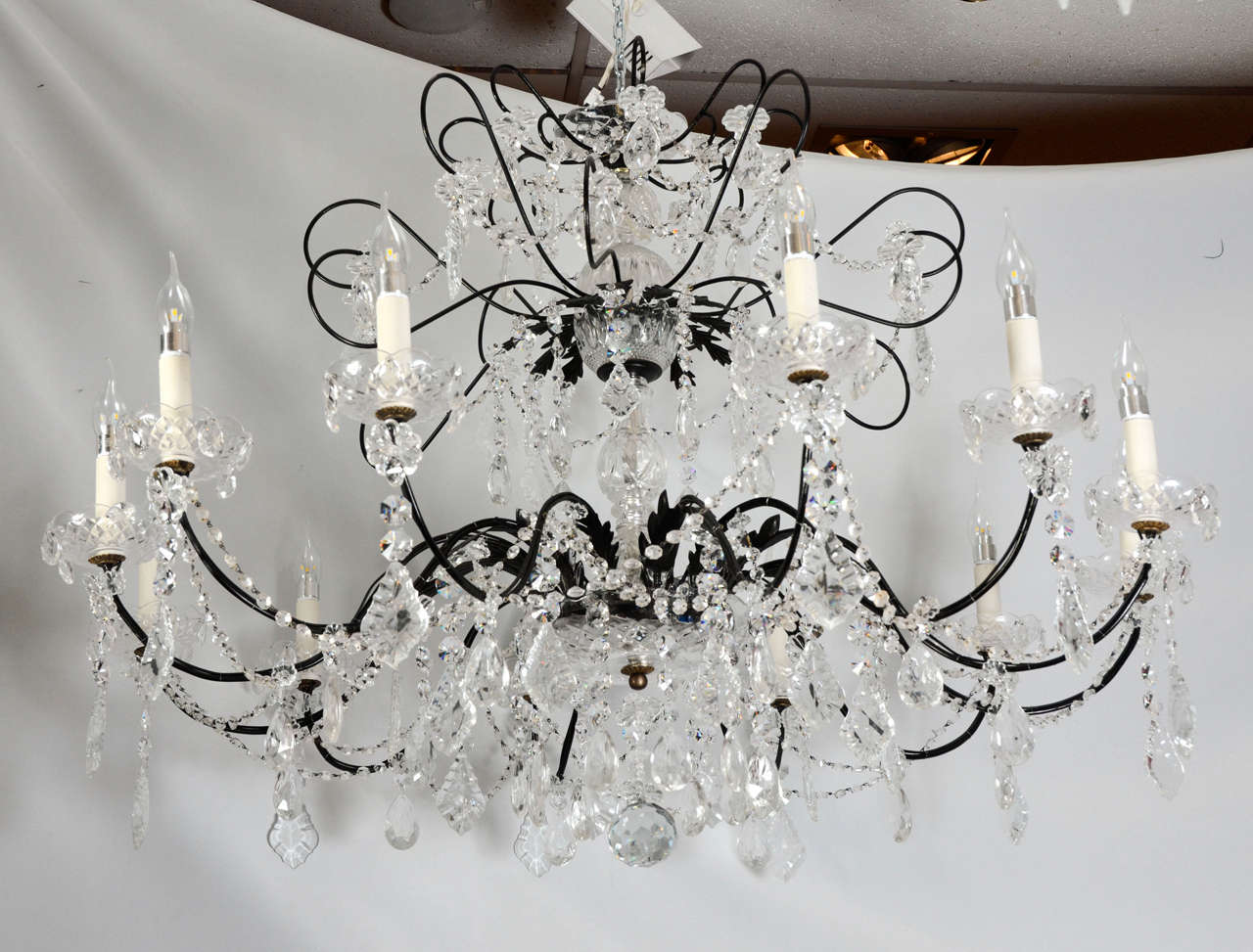 This crystal chandelier has got a very unusual shape because it is wider than high.Its proportions make it very elegant .