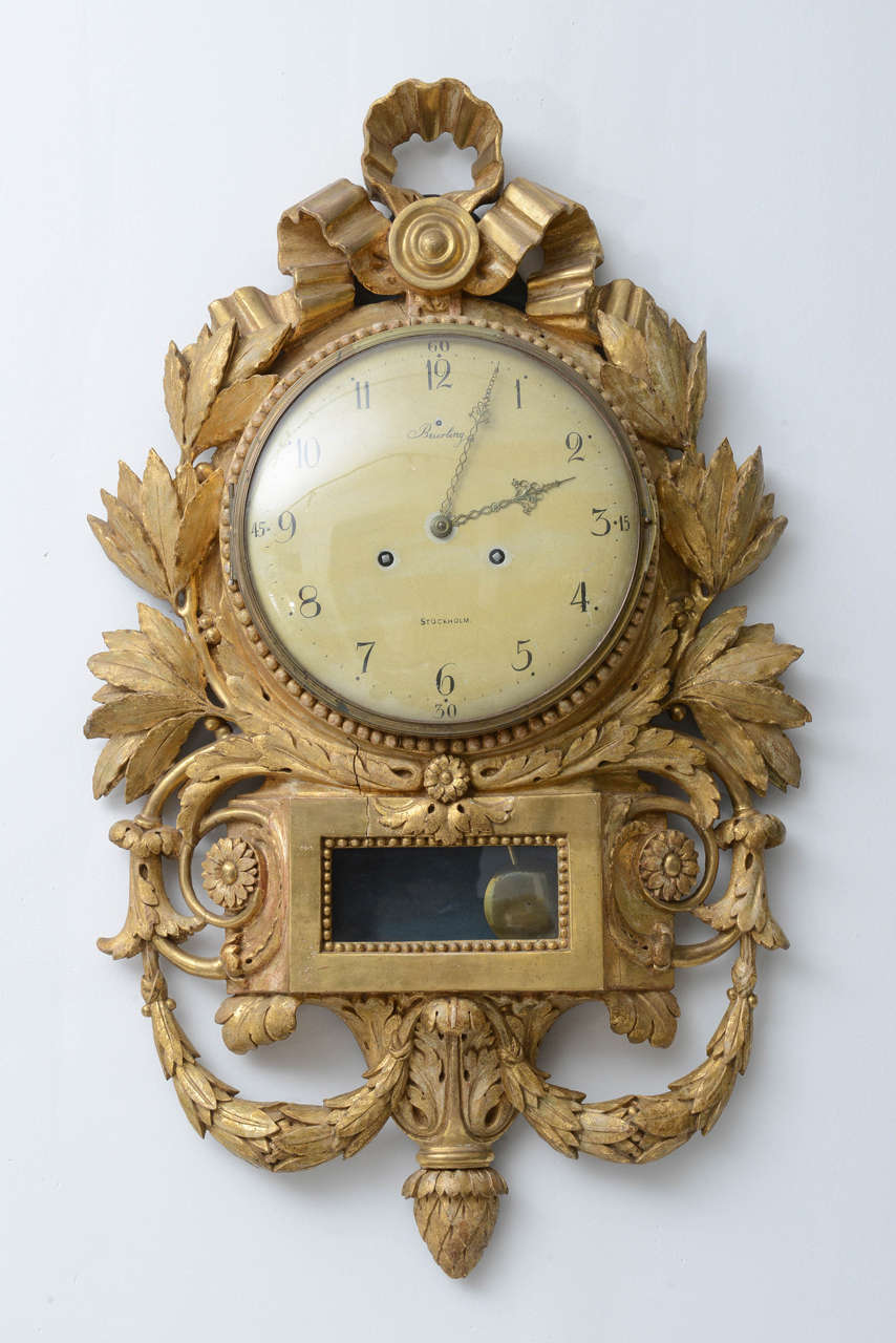 Water Gilded Wall Clock from Sweden Signed Beurling, Stockholm from 1780s. The face of the clock is covered with opening original glass cover. Ornate with leaves and wreaths the clock is topped with and elegant bow. Good antique condition, there is