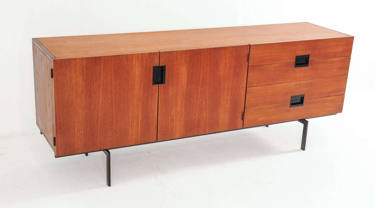A Dutch design classic; the mid-sized DU04 sideboard by Cees Braakman for Pastoe with the distinctive rounded on the inside anti-dust drawers, black sunken door handles and the elegant metal legs that make it "hover."