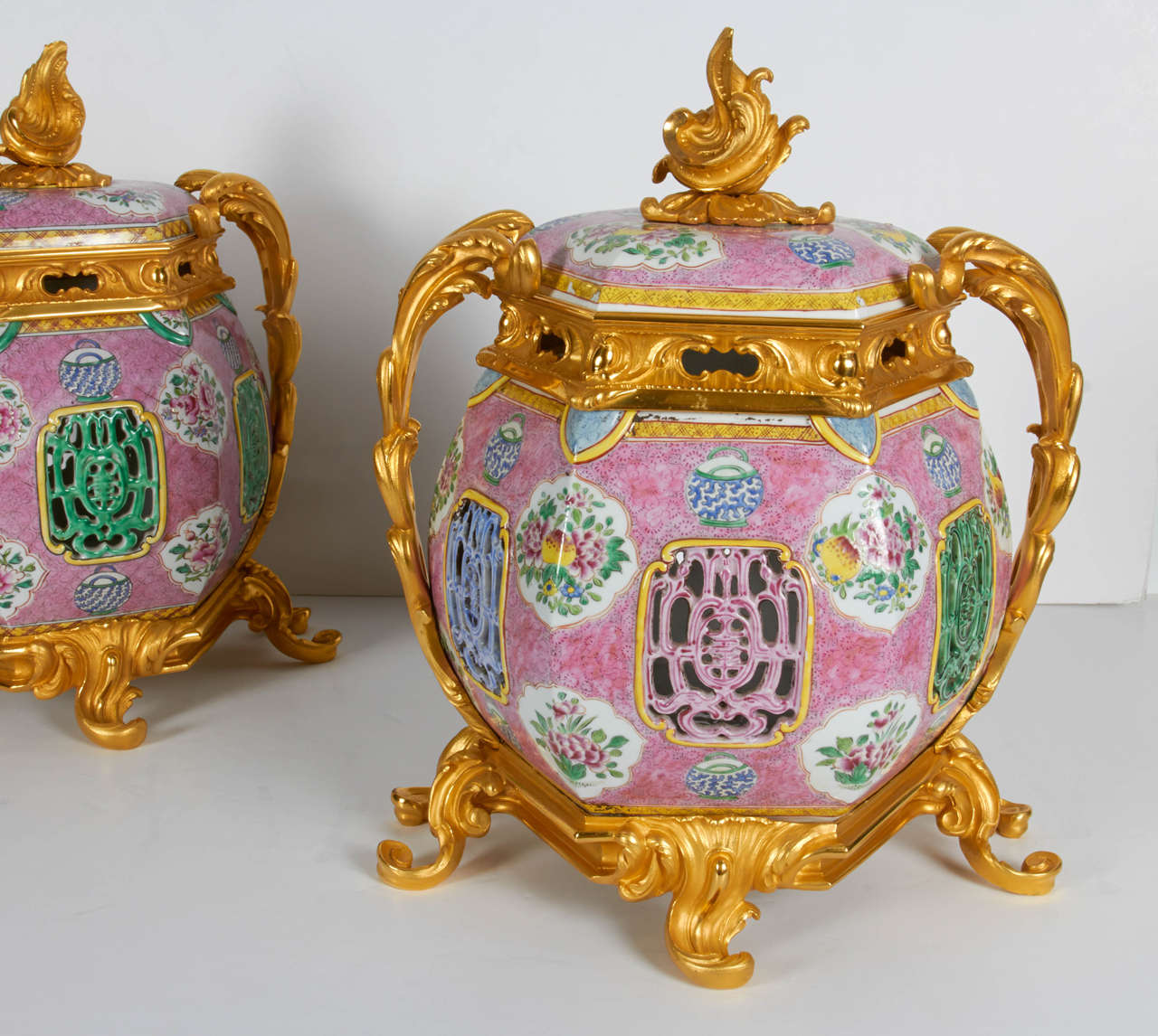 A very fine pair of antique Chinese porcelain and Louis XV-Louis XVI transitional, French doré bronze mounted covered potpourri/urns. These beautiful and quite decorative covered vases are truly spectacular in person and pretty large in scale. The