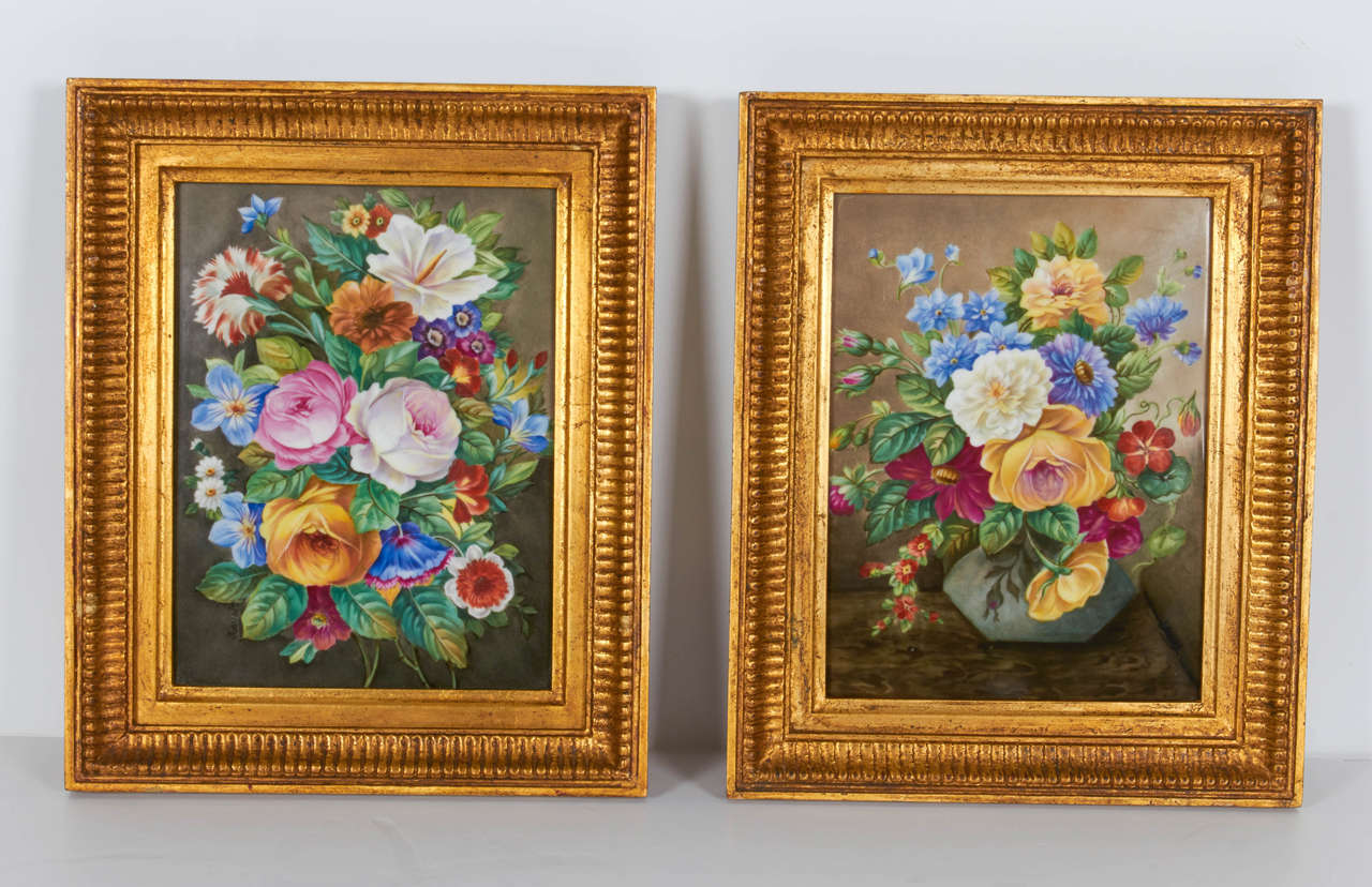 A fine pair of hand-painted porcelain plaques of floral still-life paintings with original giltwood frames. These beautiful floral still-life paintings have been hand-painted on porcelain plaques. The flowers are all very finely detailed and