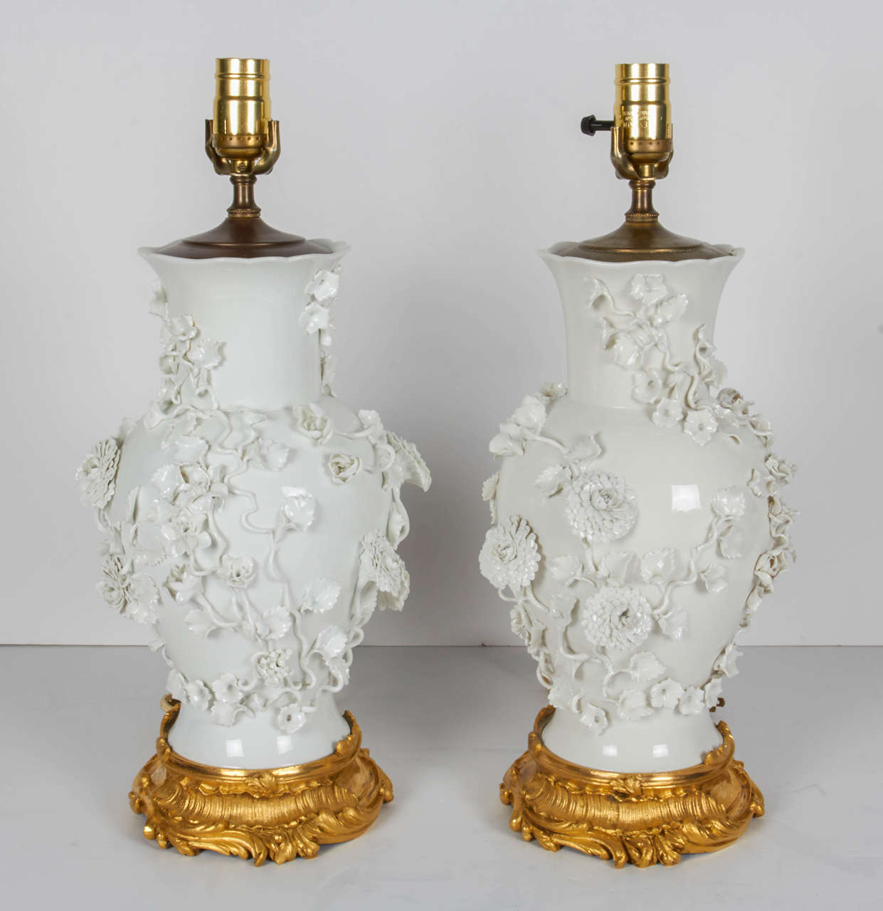 Pair of Antique Blanc de Chine Porcelain Lamps with Raised Flowers at