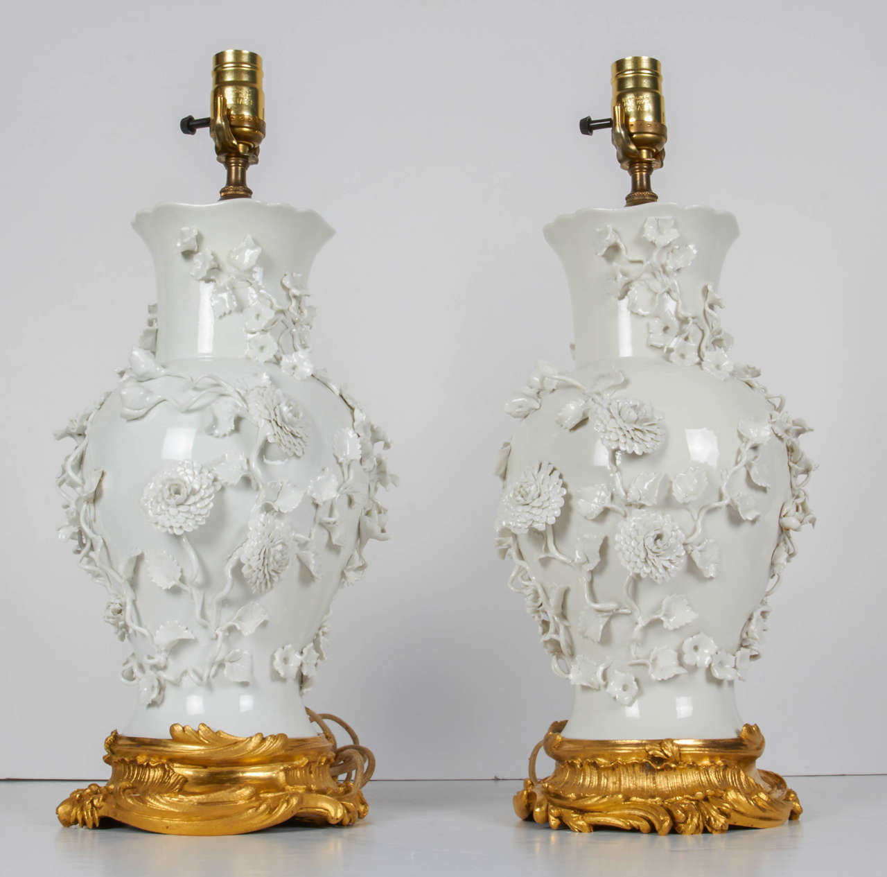 Pair of Antique Blanc de Chine Porcelain Lamps with Raised Flowers at