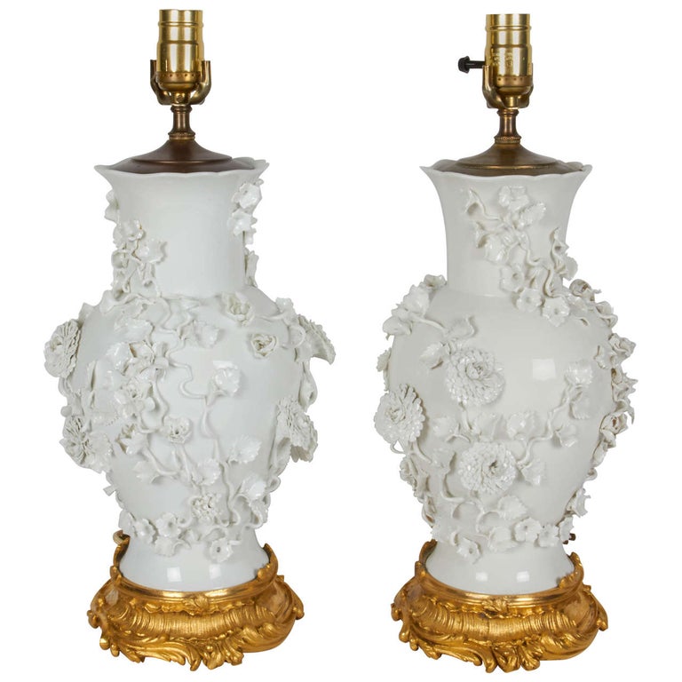 Pair of Antique Blanc de Chine Porcelain Lamps with Raised Flowers.