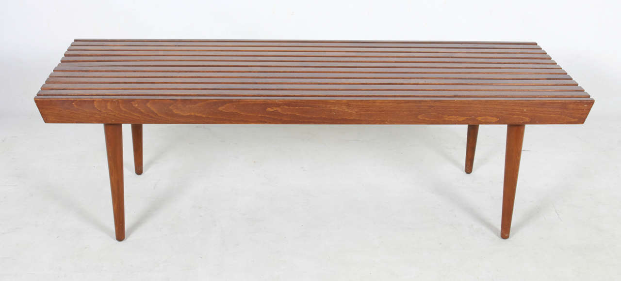 Cleanly designed in a medium scale, this slat bench is both handsome and versatile. Please contact for location.
