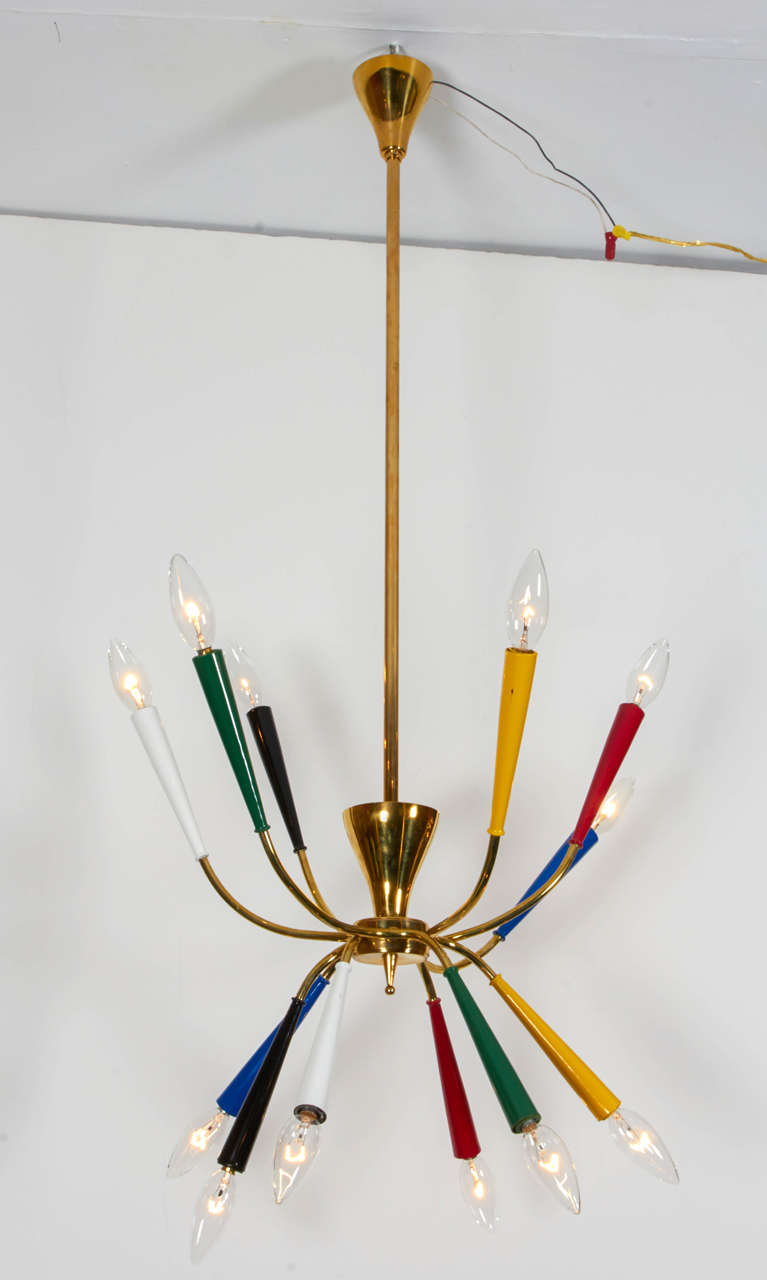 Wonderful sculptural chandelier pendant! Brass armature, rod and original canopy. Accented with enameled cones in primary colors. A delightful piece by Arredoluce; Italy, 1950s. This piece is multi- configural; you may adjust the arms in a variety