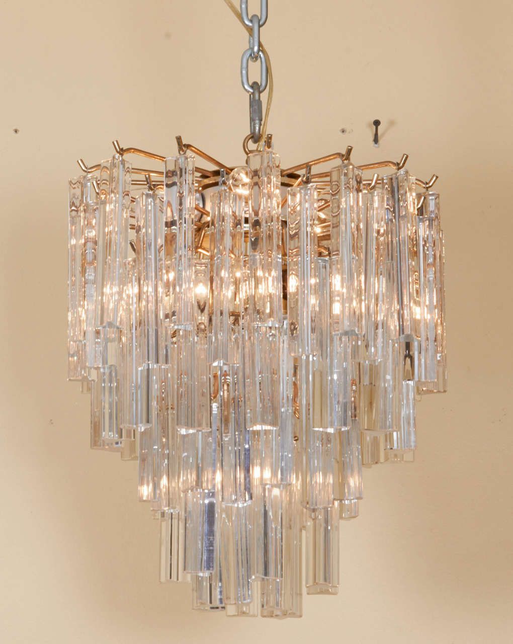 Lovely multi tiered murano crystal chandelier with a brass armature. This piece is a medium size and in a versatile scale. Please contact for location.