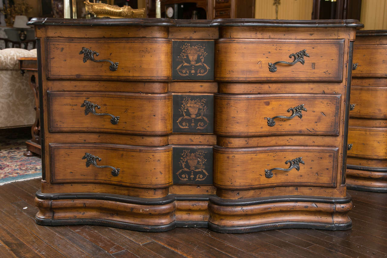 A nice large pair of chests, or commodes, with serpentine fronts. The pair are paint decorated, and have nice drawer pulls. They are made intentionally to look distressed, as if they were 18th century.