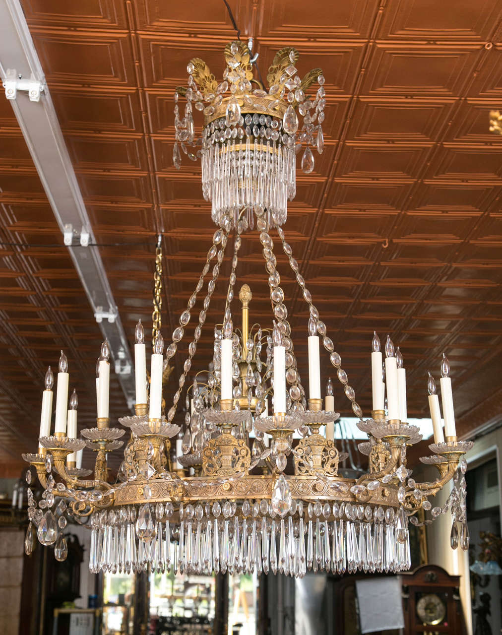 This magnificent Russian Empire doré bronze chandelier is excellent quality and elegant as can be as it is draped with wonderful crystal garlands. With two tiers of lights, the casting of the bronze is of very high quality. Having it's original