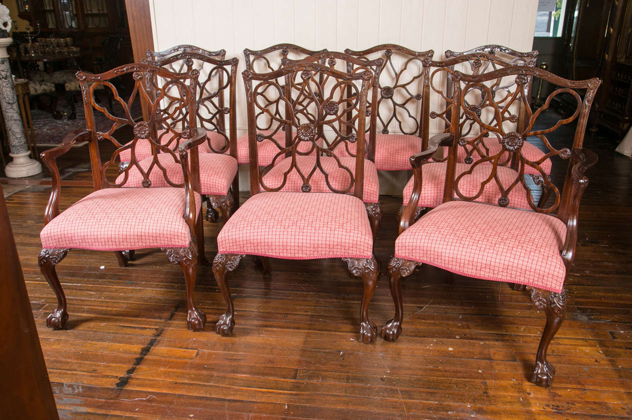 A handsome set to ten carved mahogany wheel back dining chairs, in the style of Chippendale. The set consists of two armchairs, and eight side chairs.
Measures: The height of the chairs is 40.5