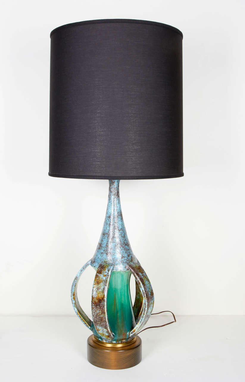 Outstanding Mid-Century Modern glazed stoneware lamp. The lamp has an unusual sculptural design in the form of an elongated vessel with open slats along the lower portion. Beautifully handmade pottery in extraordinary matte glazed finish of