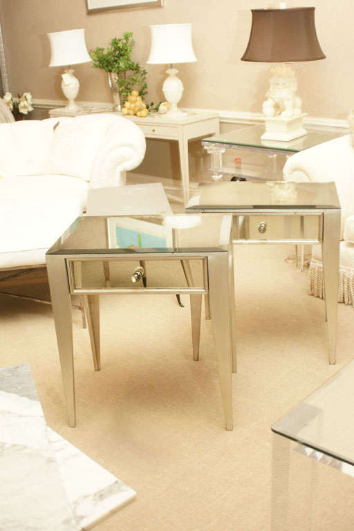 Attractive pair of mirrored 1-drawer nite stands. The legs are silver leafed. The top is antiqued mirror with a 1 inch bevel.