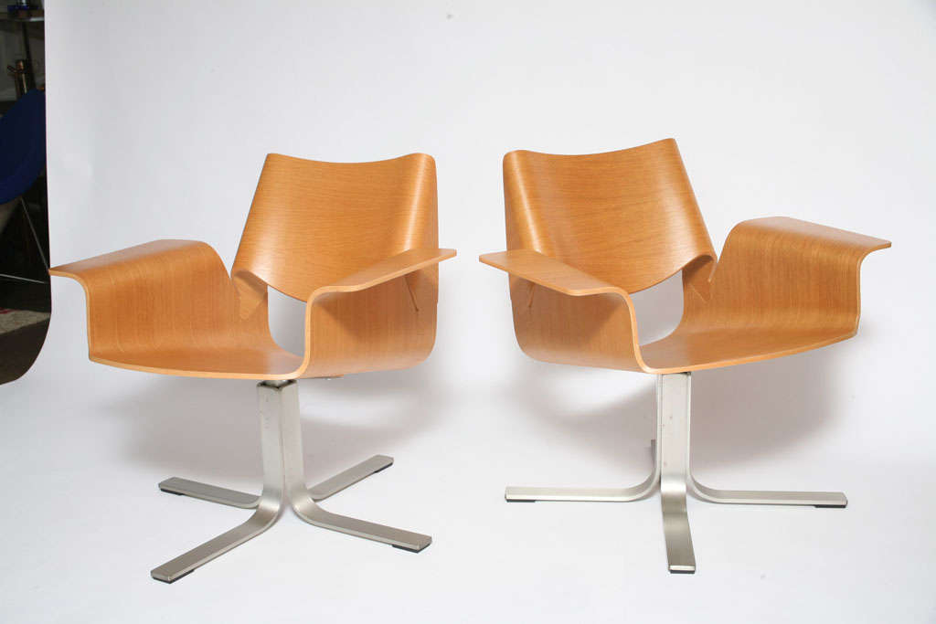 Great looking pair of swivel lounge chairs crafted of bent plywood on star brushed aluminum base.